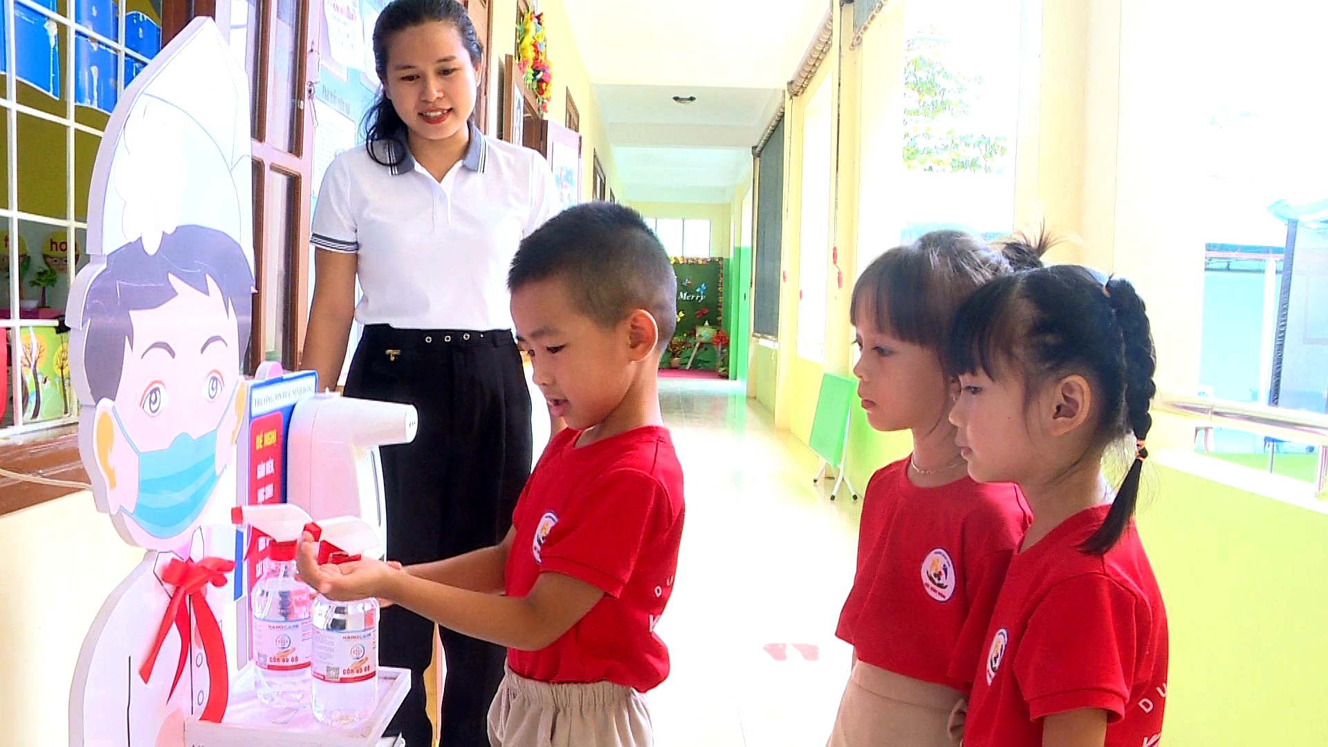 Học sinh khử khuẩn tay trước khi vào lớp họcjpg